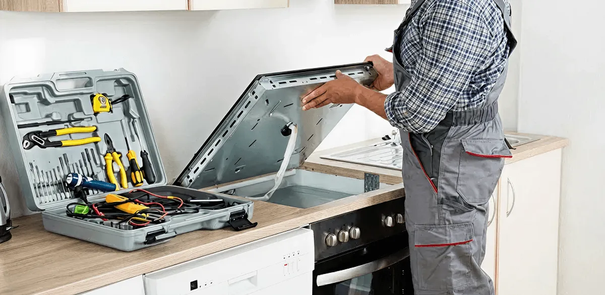 Handyman repairing a cooktop and checking wiring connections in Madison, WI