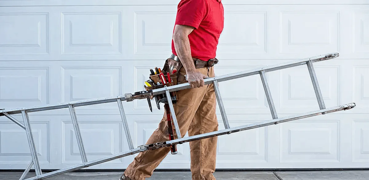Garage door repair technician arriving with tools and ladder in Madison, WI